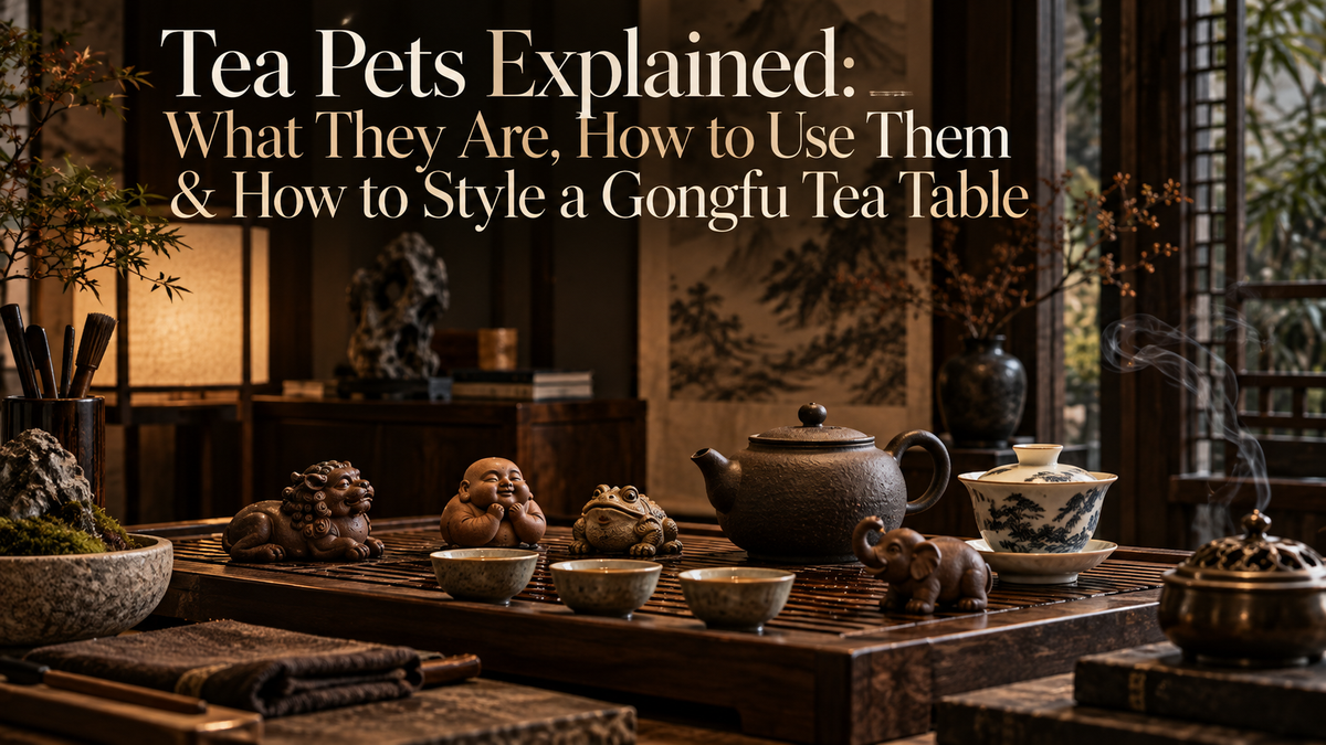 Tea pets arranged on a Gongfu tea table in a warm New Chinese tea room