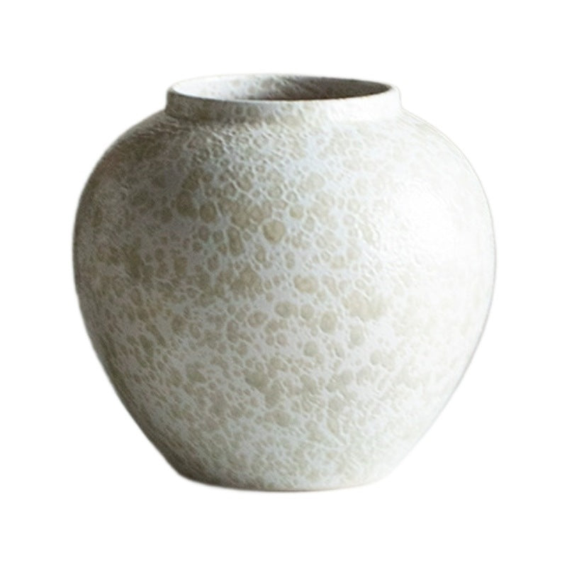 Rounded ivory white crackle ceramic vase isolated on white