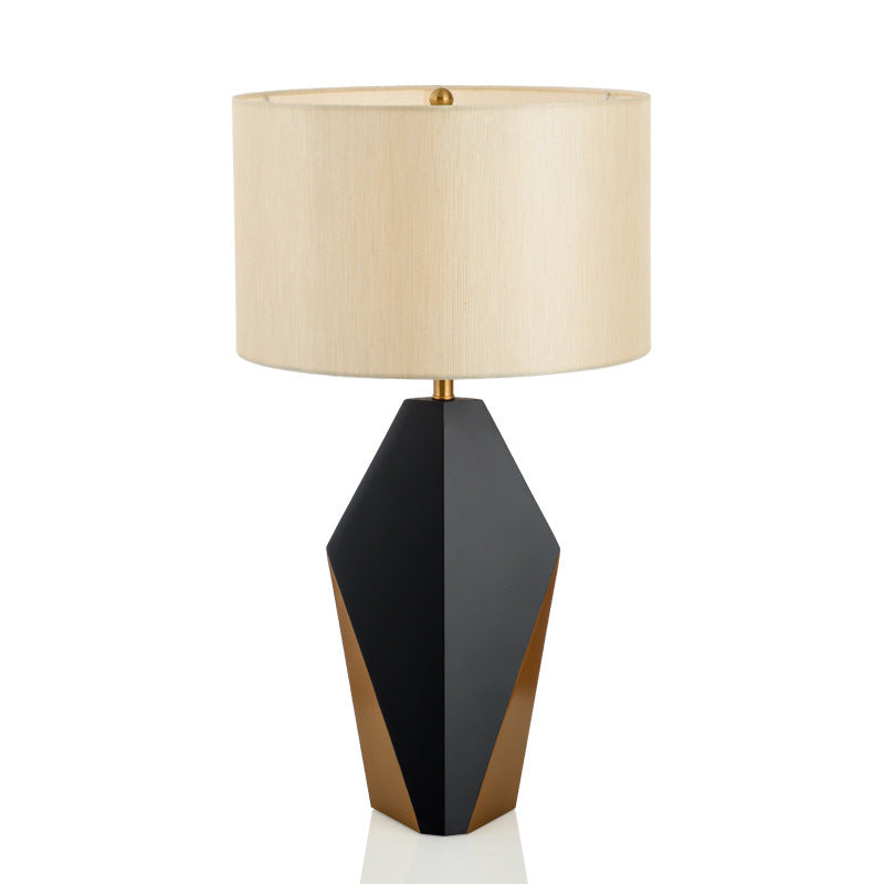 Black and gold faceted geometric table lamp with ivory fabric drum shade front view
