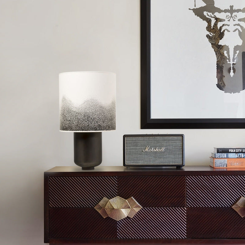 Black metal table lamp with black-to-white gradient fabric shade in modern interior