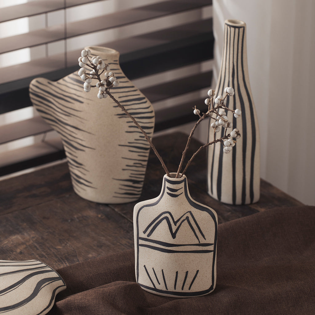 Ivory black-line art ceramic vases with tall striped and sculptural forms