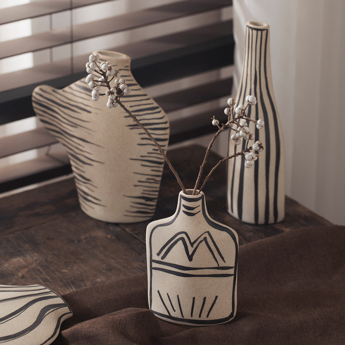 Ivory black-line art ceramic vases with tall striped and sculptural forms