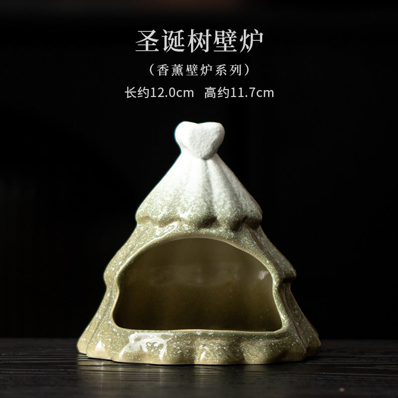 Christmas tree ceramic Palo Santo and sage fireplace burner isolated on black background