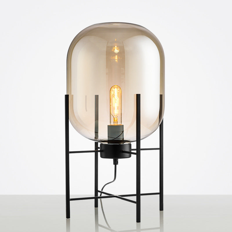 Amber capsule glass floor lamp with black frame
