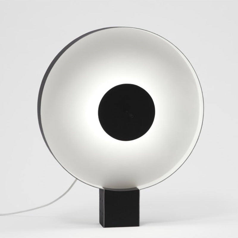Black and white circular LED table lamp front view