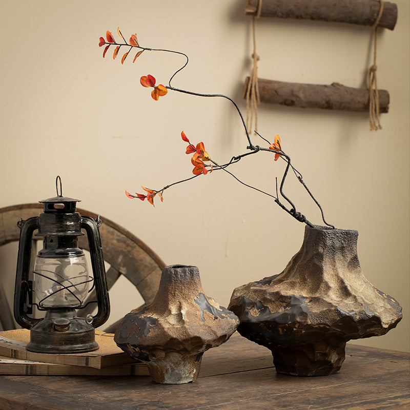 Sculptural irregular ceramic vase with black and earthy metallic surface