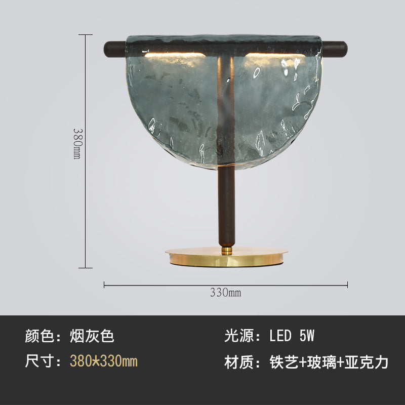 Smoke grey half moon glass lamp with black stem and round gold base