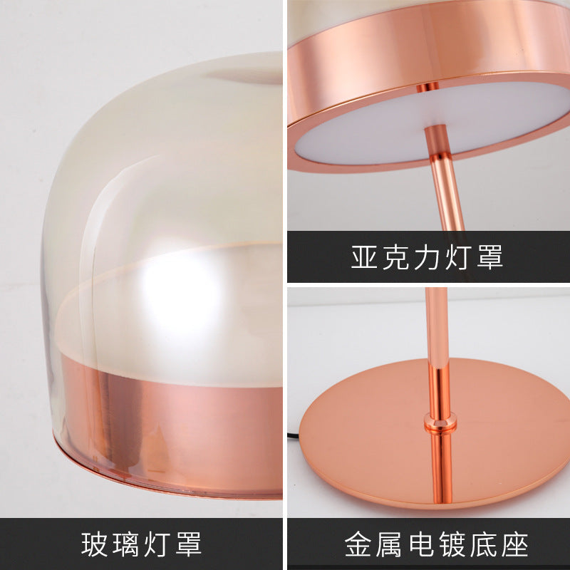 Glass dome and electroplated metal base detail on rose gold table lamp