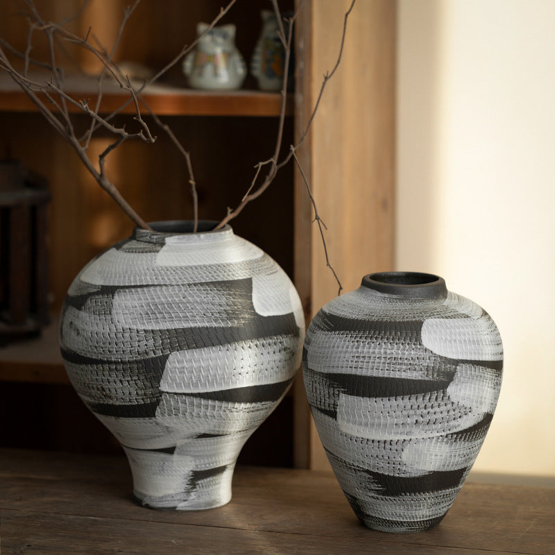Rounded black and white ceramic vase pair with graphic brush texture