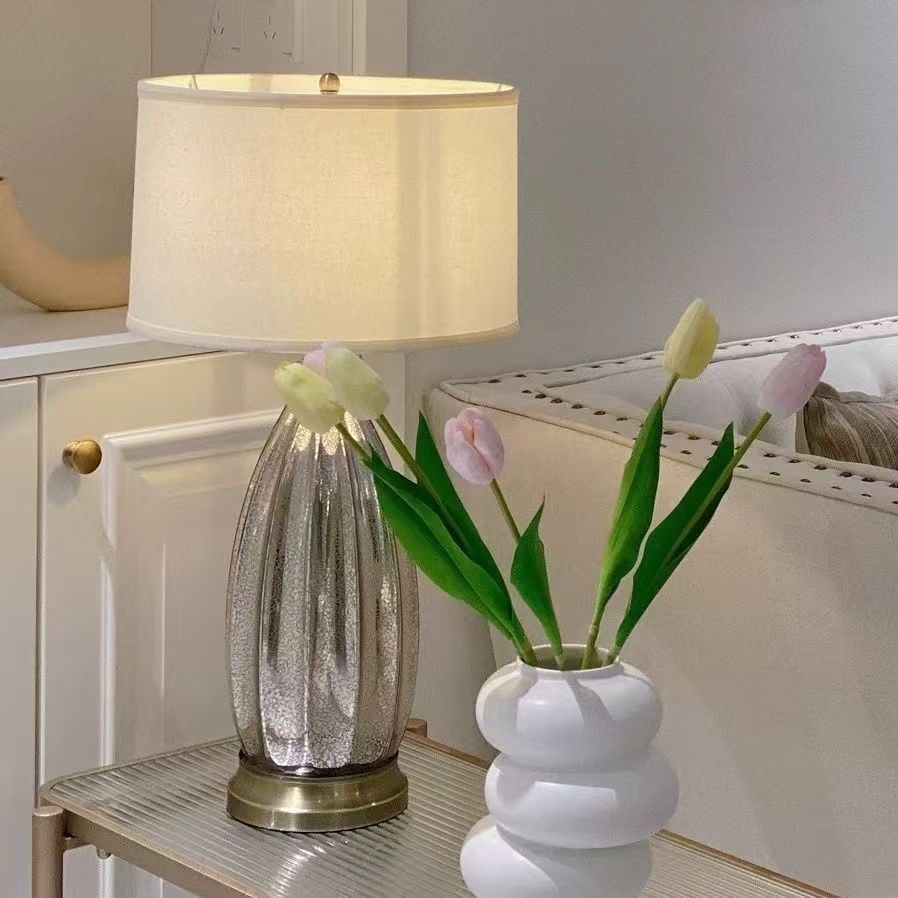 Small silver ribbed glass bedside lamp with white fabric shade