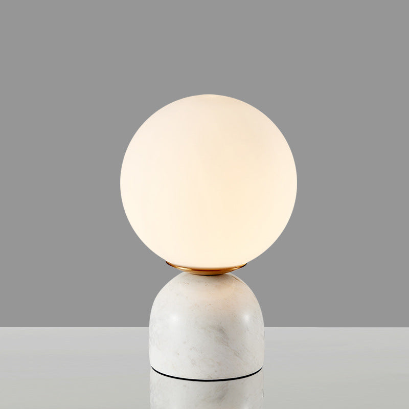 White marble globe table lamp with opal glass sphere