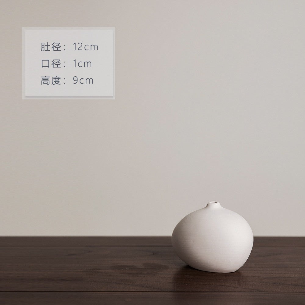 Matte ivory round pebble mini ceramic bud vase, 9 cm high