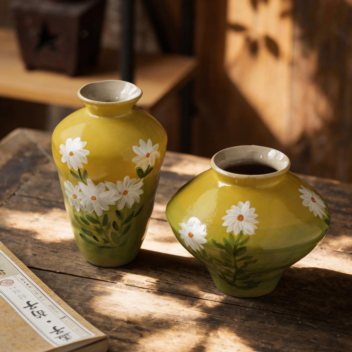 Mustard yellow hand-painted daisy ceramic vase pair on rustic table