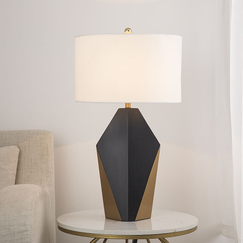 Black and gold faceted table lamp styled on marble side table