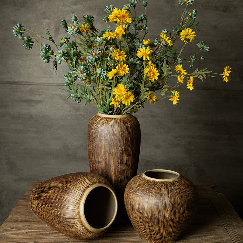 Bronze brown brushed ceramic vase trio styled with yellow flowers