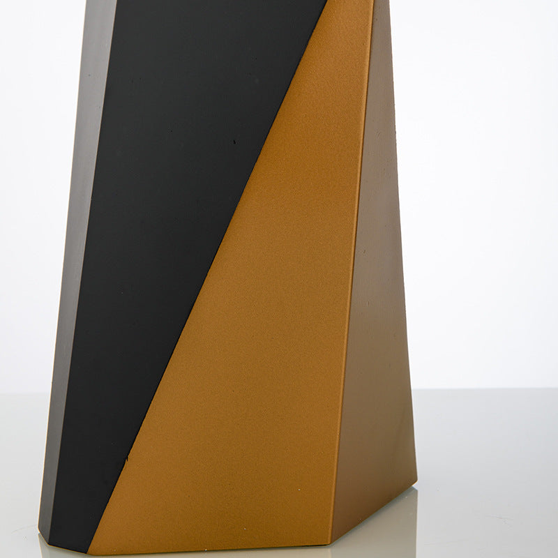 Close detail of black and gold faceted metal table lamp base