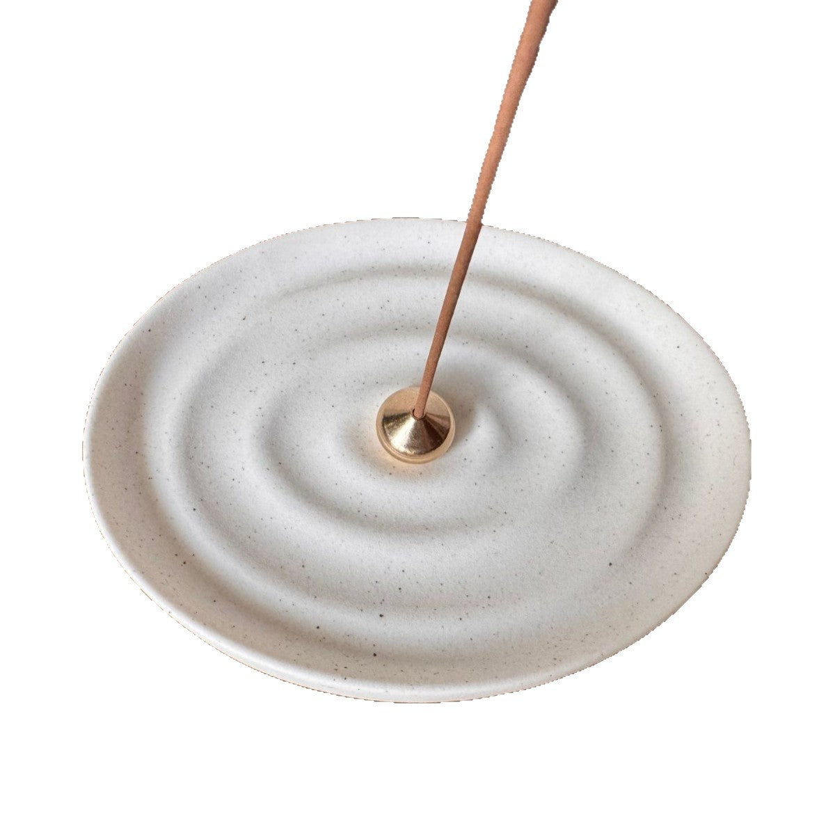 White ceramic ripple incense plate with brass incense holder isolated on white