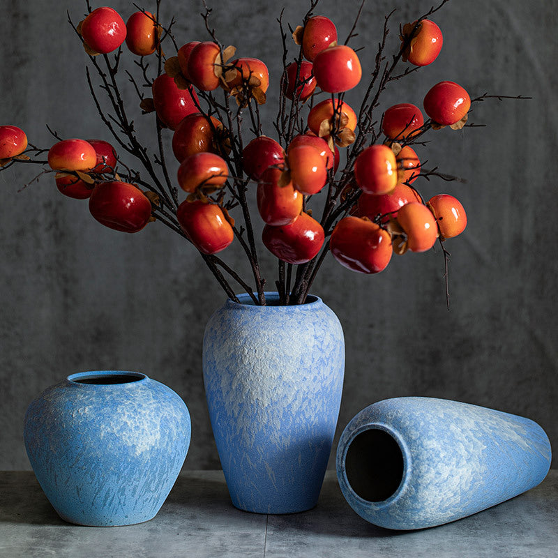 Sky-blue ceramic vase trio with autumn persimmon branches