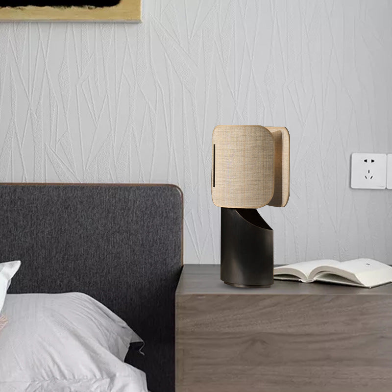 Modern designer fabric shade table lamp on dark wood bedside table