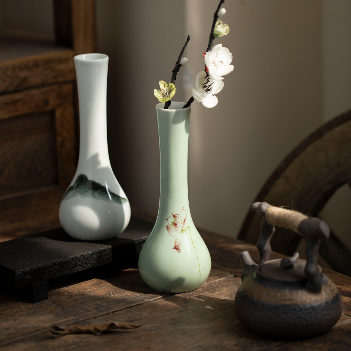 Celadon floral and black mountain ceramic bud vases styled with blossom branch