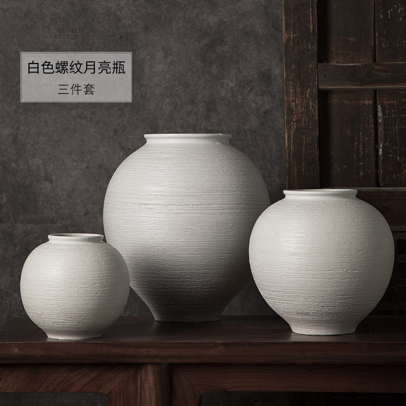White ribbed round ceramic vases in three sizes
