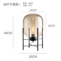 Amber glass cage lamp 28cm by 42cm with black metal frame
