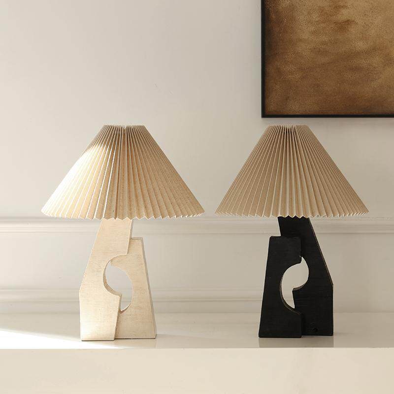 Black and beige resin arch table lamps shown together
