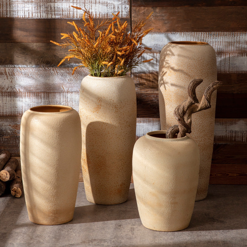 Beige sand-texture floor vases styled with dried orange foliage