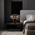 Smoke grey UFO glass table lamp with exposed filament bulb and black base