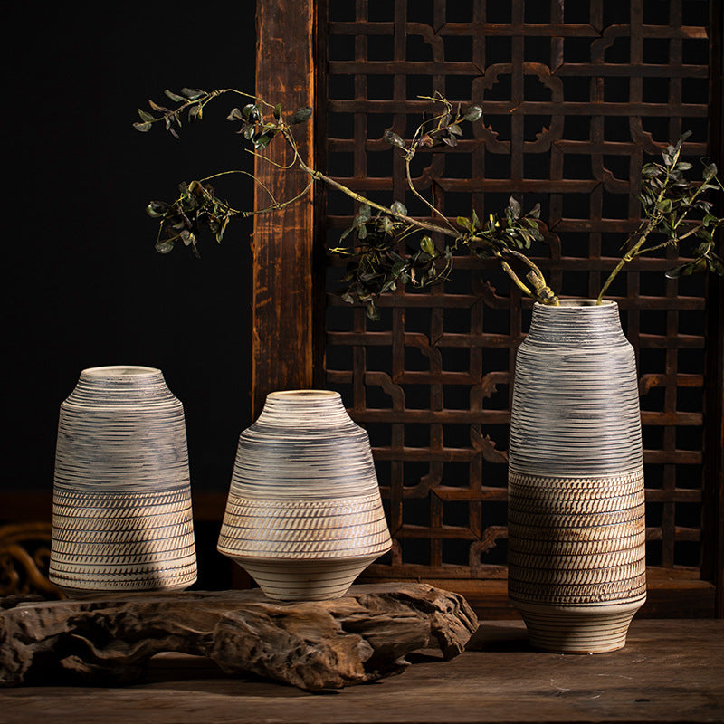 Three grey ochre striped textured ceramic vases displayed together