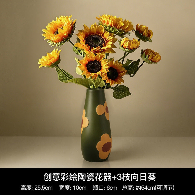 Olive green tall hand-painted ceramic vase with raised flower motifs and sunflower bouquet