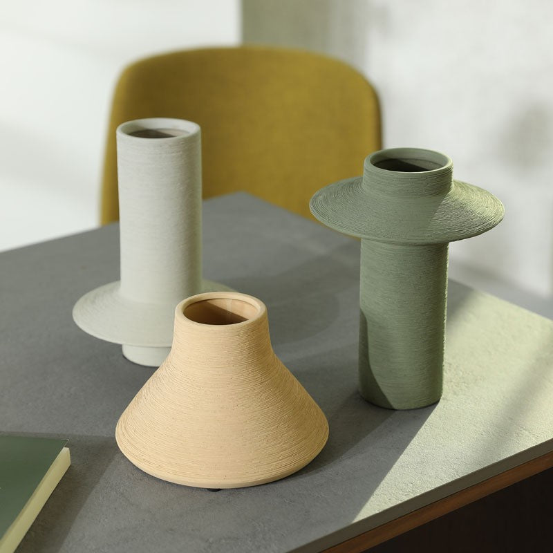 Morandi grey green and sand yellow textured ceramic vase trio on dining table