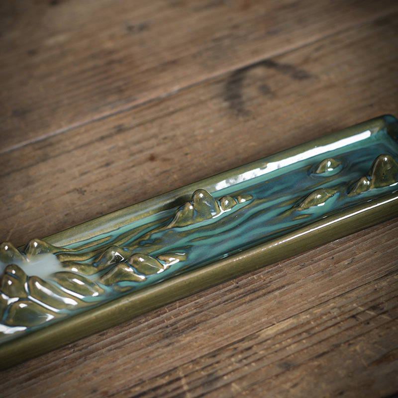 Close view of kiln glazed mountain landscape ceramic incense tray