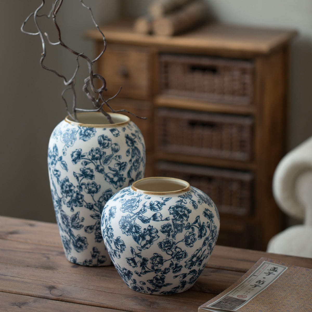 Blue floral ceramic vases styled with sculptural branch