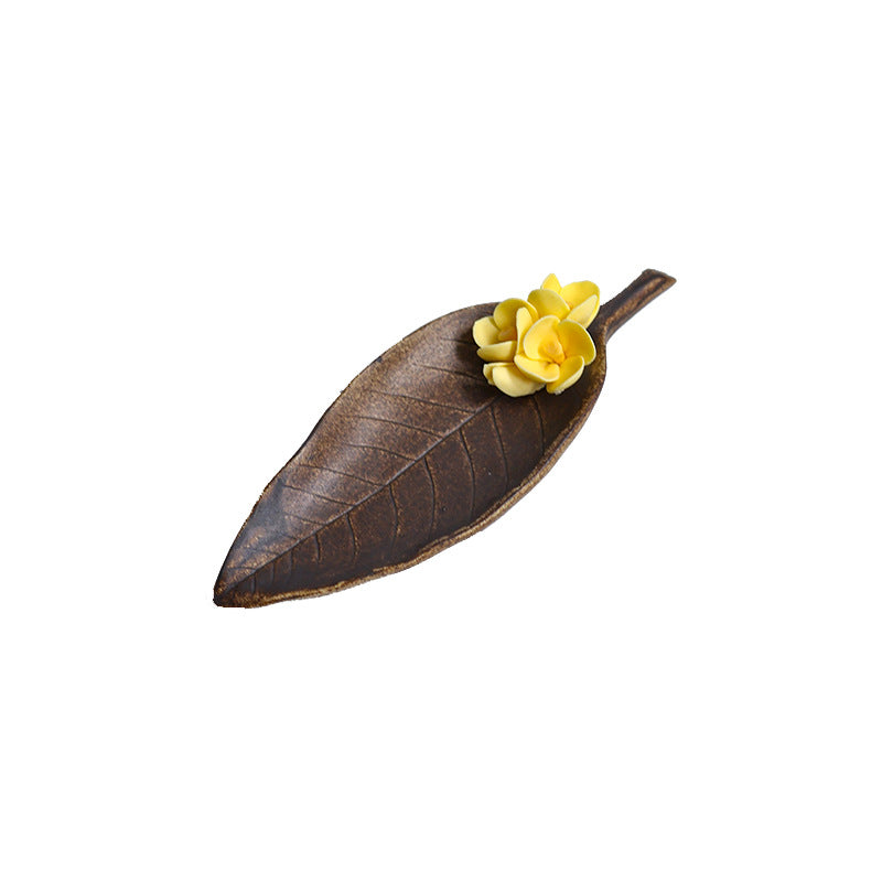 Leaf shaped osmanthus ceramic incense holder isolated on white background