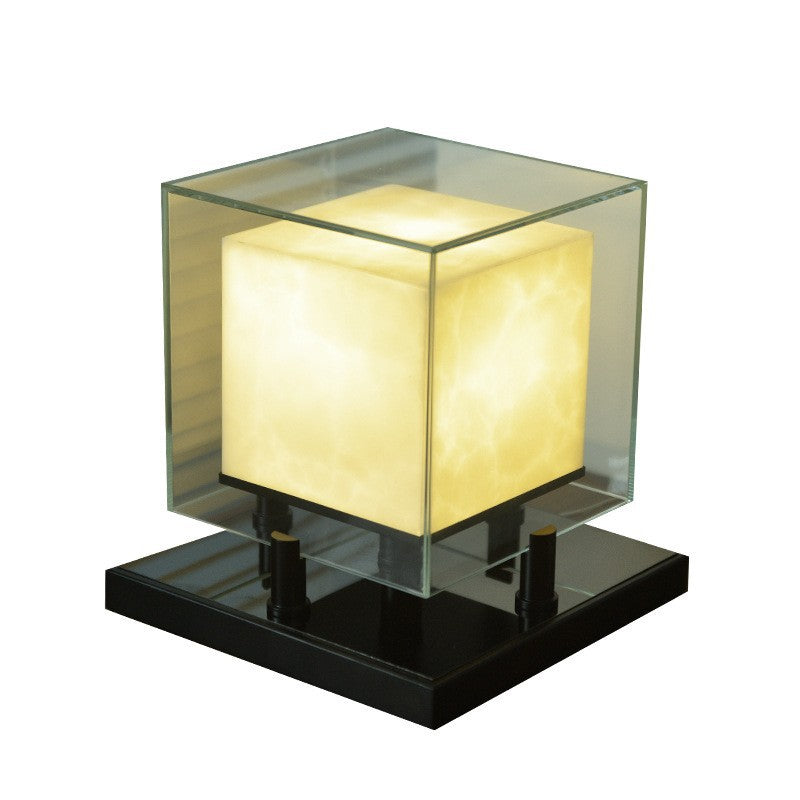 Small cube table lamp with glowing alabaster-style core on black base