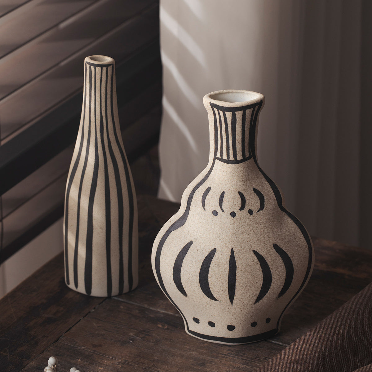 Ivory black-line art tall bottle and onion ceramic vase pair
