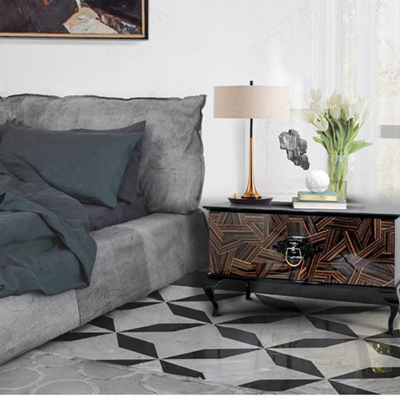 Black brass fabric shade table lamp styled beside upholstered bed