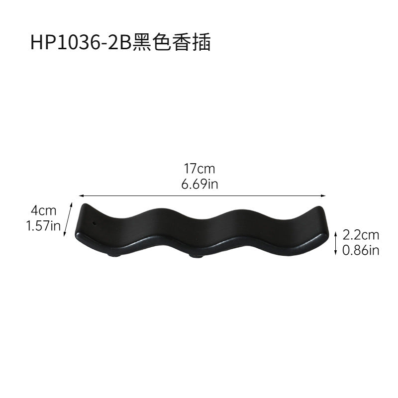 Matte black wavy ceramic incense tray approximately 17 cm long