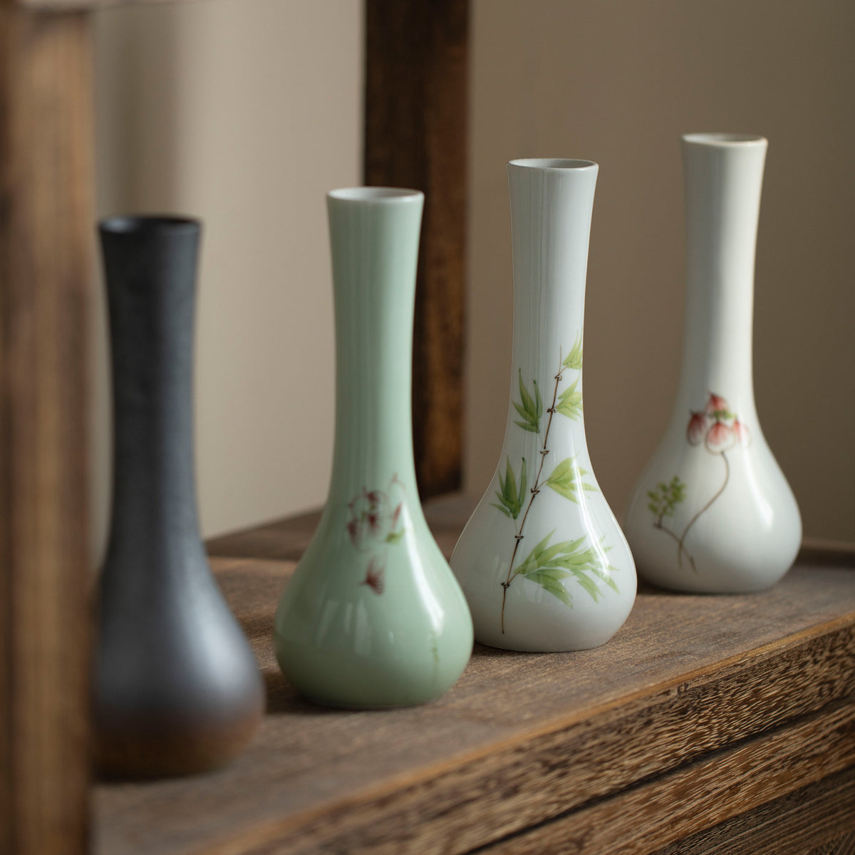 Six long-neck ceramic bud vase styles displayed together