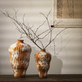 Terracotta orange and white textured ceramic vases in two sizes with bare branches