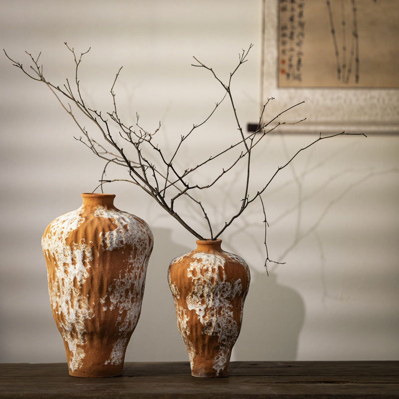 Terracotta orange and white textured ceramic vases in two sizes with bare branches