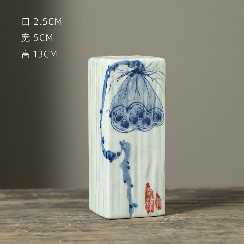 Hand-painted blue white rectangular ceramic bud vase with lotus motif, 13 cm