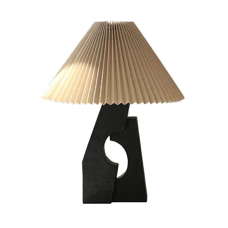 Black sculptural pleated shade table lamp illuminated