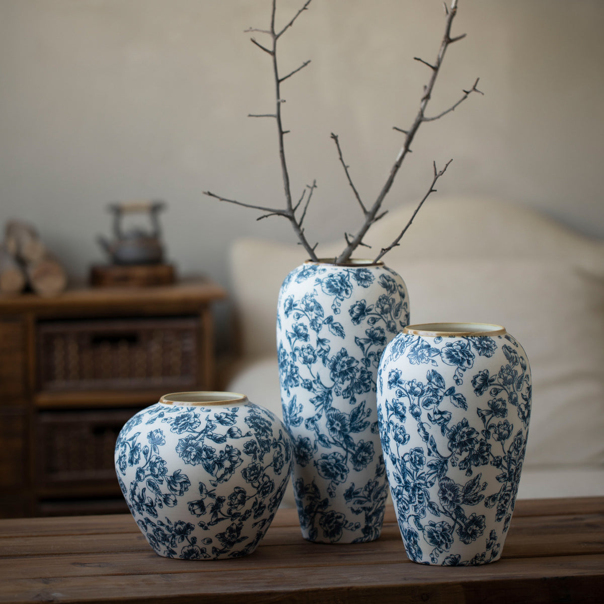 Blue botanical ceramic vase trio with bare branches