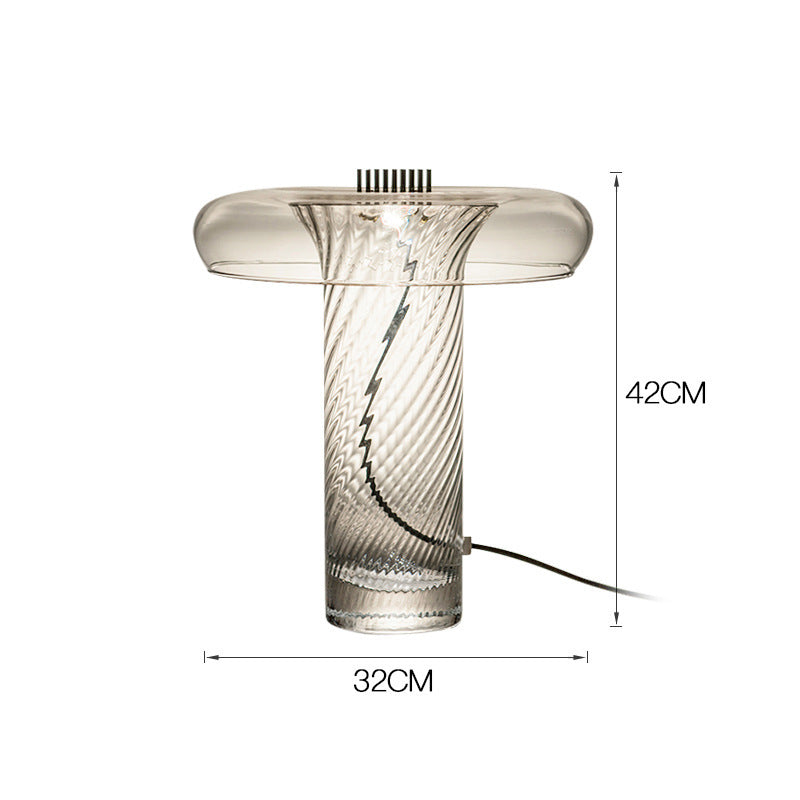 Clear sculptural glass mushroom lamp styled on modern console