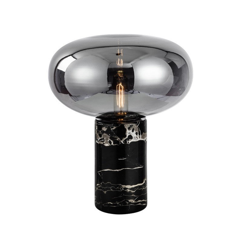 Amber glass and marble table lamp styled on bedside table