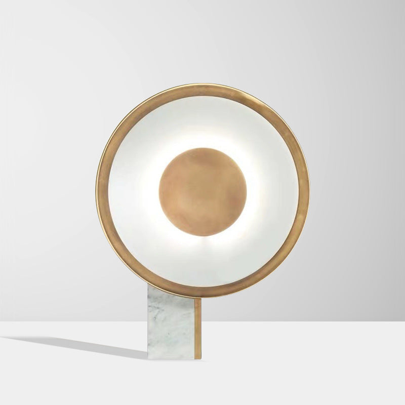Gold circular LED halo lamp on white marble base product view