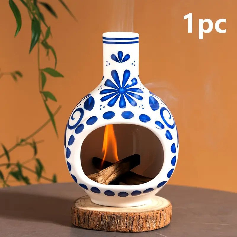 Blue floral ceramic Palo Santo burner with lit sacred wood in front chamber
