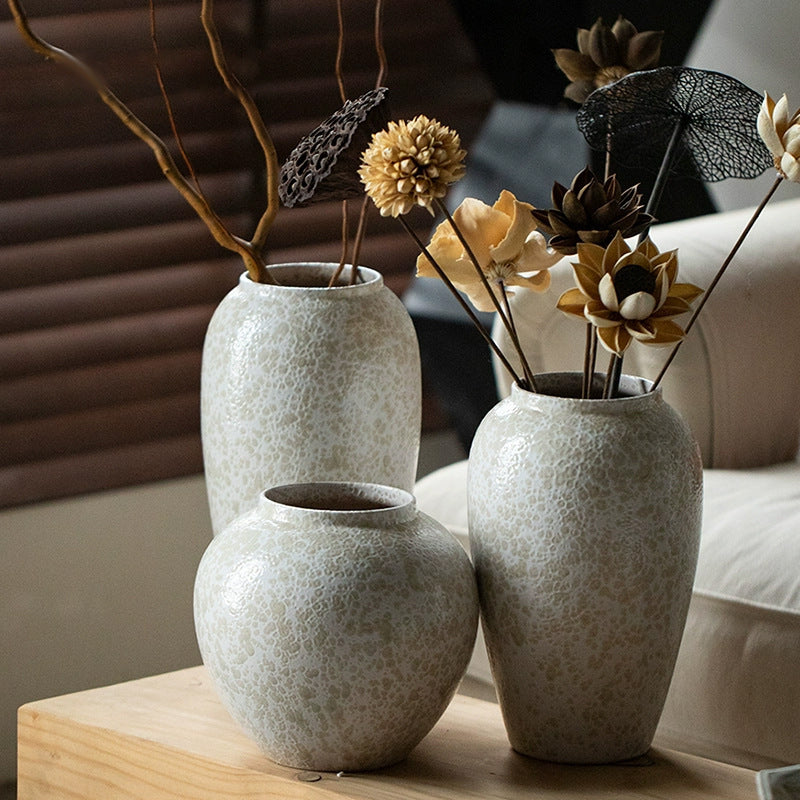 Three ivory white textured ceramic vases in warm interior